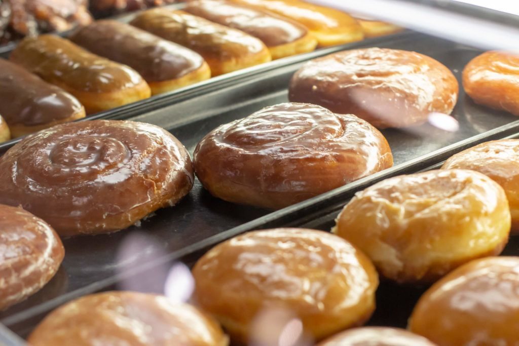 Glazed donuts and iced bars in the case at The Donut Run in Utah