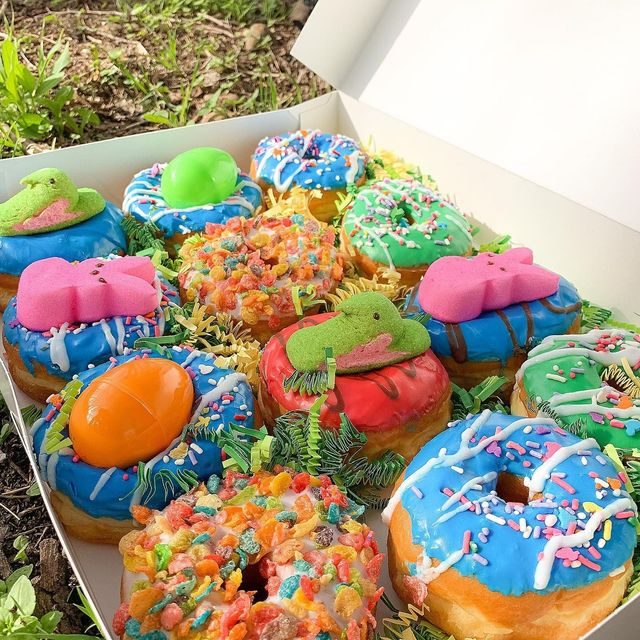 A custom decorated donut box from The Donut Run with pastel icing and sprinkles